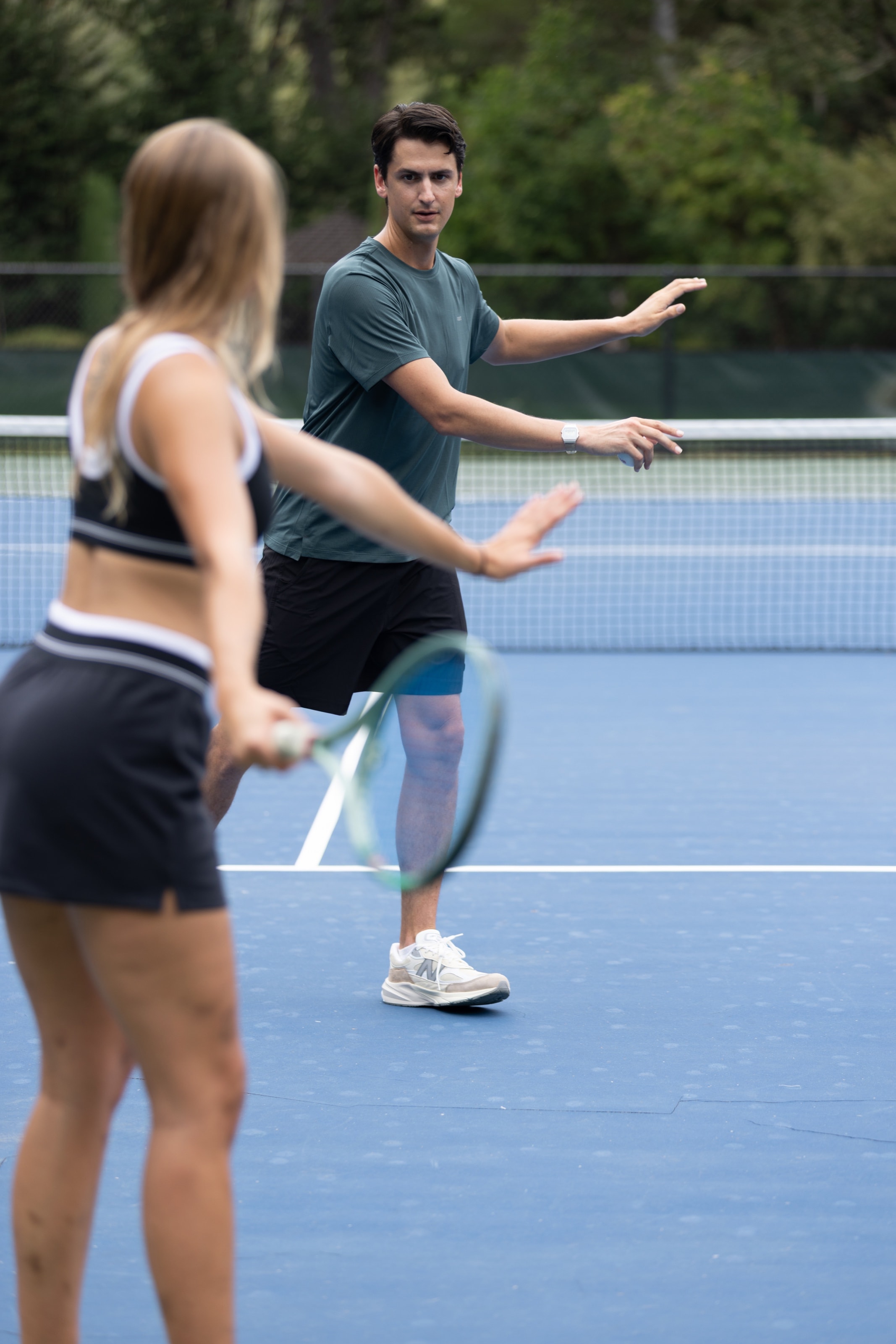 Mark Douglas Foti demonstrating tennis positioning with Amelia on court.